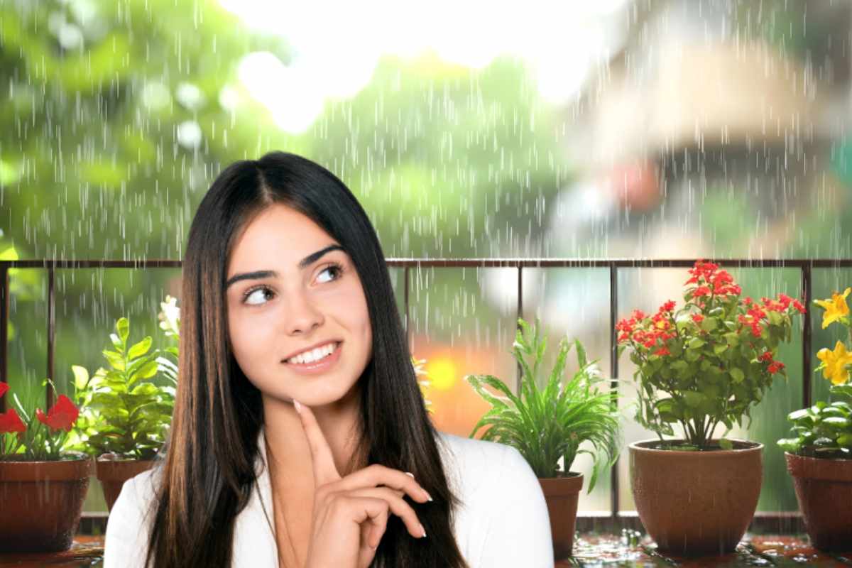 donna che pensa con balcone sotto la pioggia sullo sfondo