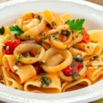 piatto di pasta bianco con calamarata