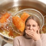 pentola con frittura e donna che sente puzza