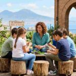 Lezione all'aperto di scienze all'IC Salvemini di Napoli con vista sul Vesuvio: studenti usano un microscopio nell'orto didattico.