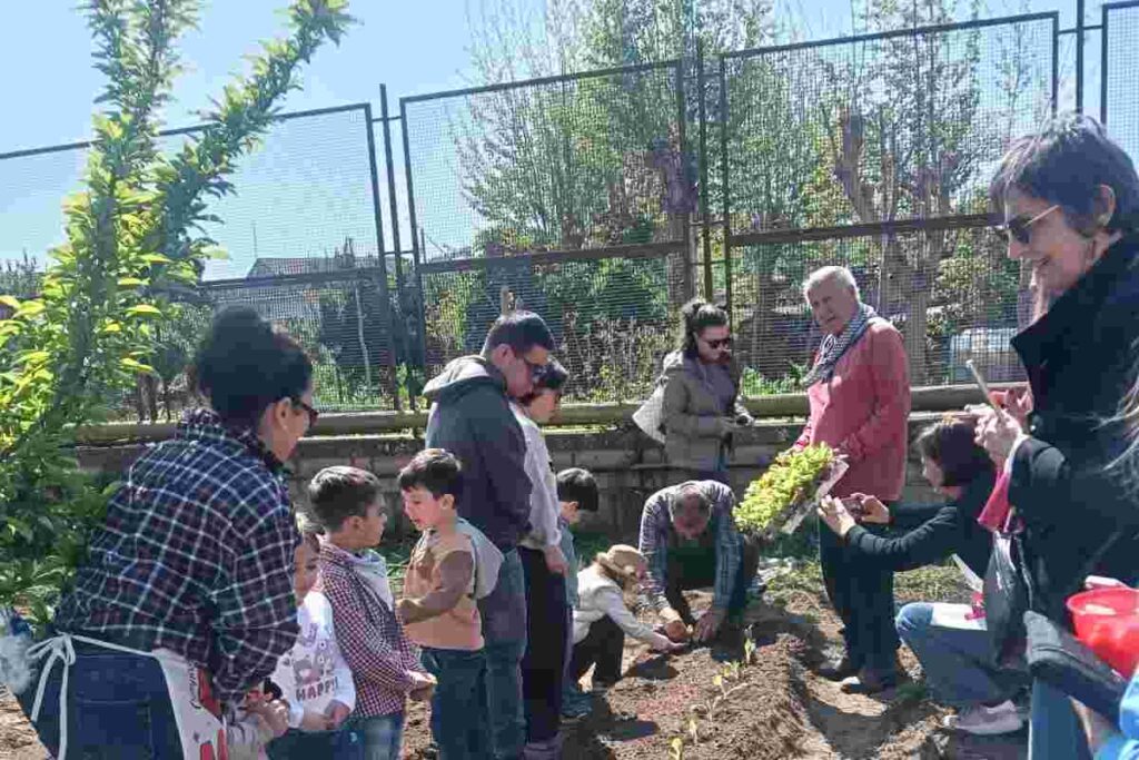 Scolari ed insegnanti all'aperto durante l'orario didattico.